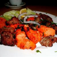 Tandoori Mixed Grill · Combination of tandoori chicken, chicken tikka, lamb boti kabab, seekh kabab and tandoori sh...