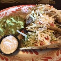 Golden Tacos · Crisp-fried tortilla tacos of shredded chicken or beef with lettuce, sour cream, tomato and ...