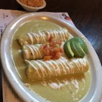 Enchiladas Suizas · 3 rolled chicken enchiladas with creamy tomatillo sauce topped with sour cream and avocado. ...
