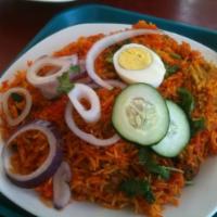 Chicken Biryani · Chicken with herbs, spices, and onions, traditionally cooked with basmati rice.