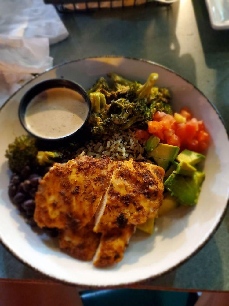 Nola Chicken Bowl · Two grilled cajun seasoned chicken breasts, roasted broccoli, avocado, diced tomato, marinated black beans, blended grains, cajun ranch 