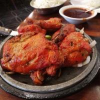 Tandoori Chicken · Marinated chicken in fresh spices and lemon then barbecued over flaming charcoal in the tand...