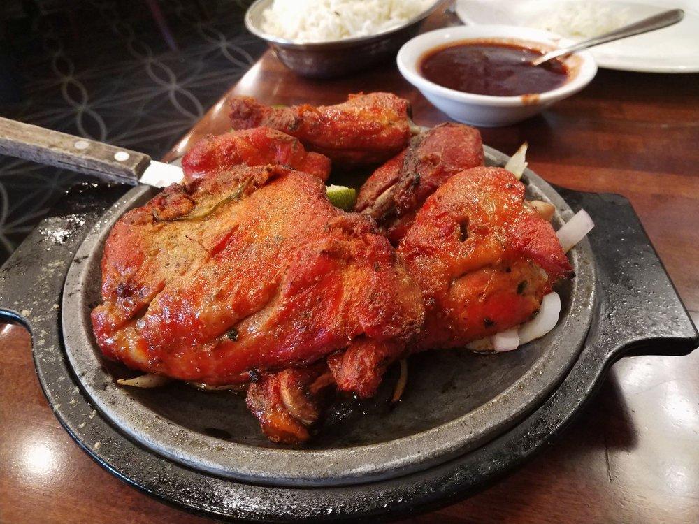 Tandoori Chicken · Marinated chicken in fresh spices and lemon then barbecued over flaming charcoal in the tandoor.