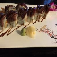 Surf and Turf Roll · Inside: shrimp tempura and spicy crab meat. On top: grilled teriyaki steak and eel sauce. Ho...