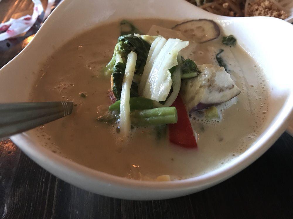Green Curry · Green curry and coconut milk with bamboo shoot, bell pepper, eggplant and basil. Spicy.