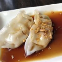 Dumplings · Steamed or Fried dumpling served with black ginger sauce.