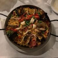 Paella Valenciana · Saffron rice with pork, chicken, chorizo, squid and mussels.