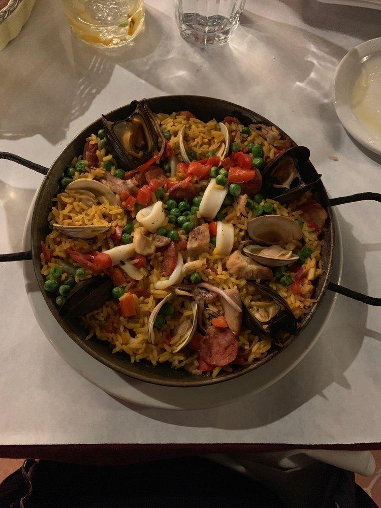 Paella Valenciana · Saffron rice with pork, chicken, chorizo, squid and mussels.