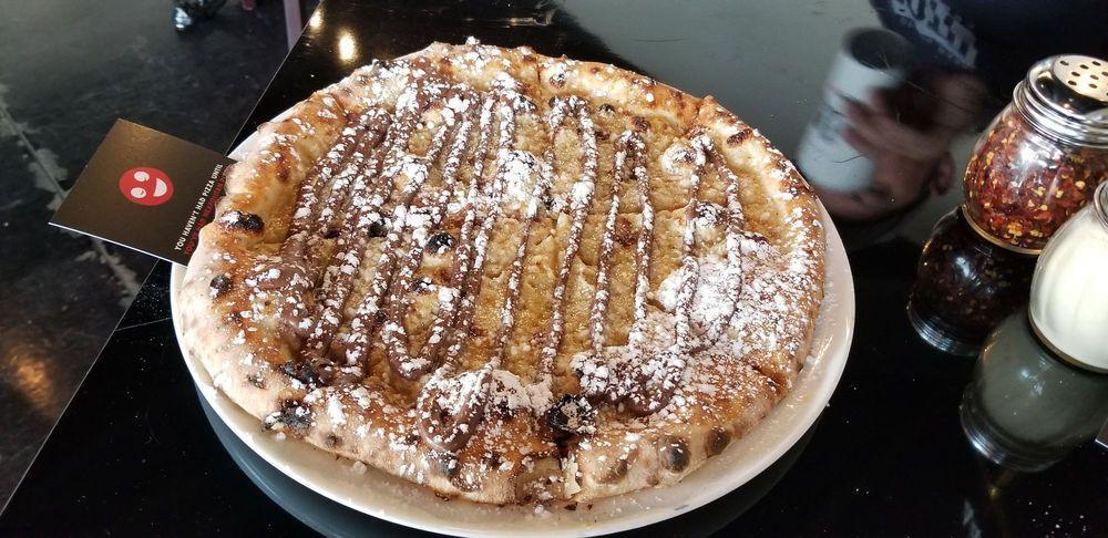 Nutella Pizza · Mascarpone base topped with Nutella and powdered sugar.