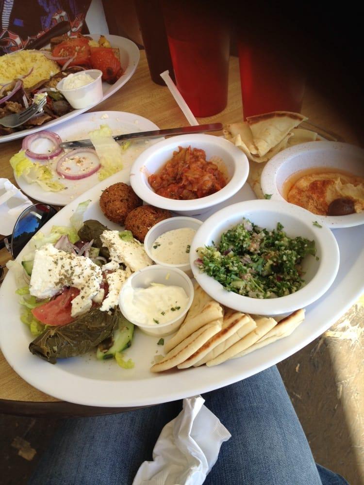 Small Tour of Greece Vegetarian Combo Plate with Pita · Vegetarian and heart healthy. A variety of tempting treats Hummus, dolmades, imam bayeldi, small tabouli salad, falafel, olives and feta cheese.