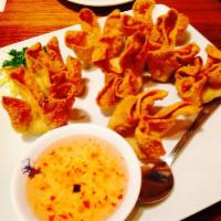Crab Delight · Deep fried wontons stuffed with cream cheese and crab meat, served with plum sauce.