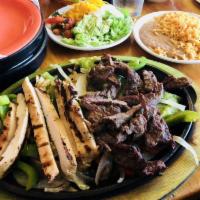 Fajitas · Chargrilled with sweet peppers and onions, served with Spanish rice, refried beans, guacamol...