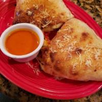 Buffalo Chicken Calzone · Spicy marinated chicken, onions, red peppers, bleu cheese crumbles, and mozzarella.