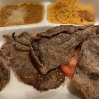 Carne Asada · Marinated thin sirloin steak, broiled to perfection and served with warm flour or corn torti...