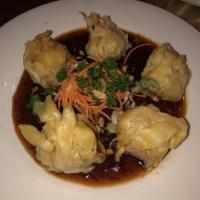 Kanom Jeep · Combination of crab meat, shrimp, chicken and water chestnuts wrapped in wonton skin then st...