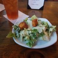 Caesar Salad · Fresh chopped romaine, tossed in Caesar dressing with jalapeno, corn bread croutons and Parm...