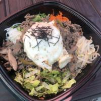 Bibimbap · Bowl of steamed rice topped with sauteed vegetables, fresh greens, bulgogi and sunny side up...