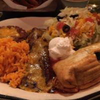 Chimichanga · Crisp burrito stuffed with prime ground beef and beans on a bed of Chile sauce. Served with ...