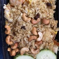 Pineapple Fried Rice · Fried rice with your choice of meat, egg, pineapple and raisins, stir fried with yellow curr...