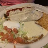 Lunch Fajita Burrito · Fajita burrito with grilled chicken or steak topped with cheese sauce and veggies. Served wi...