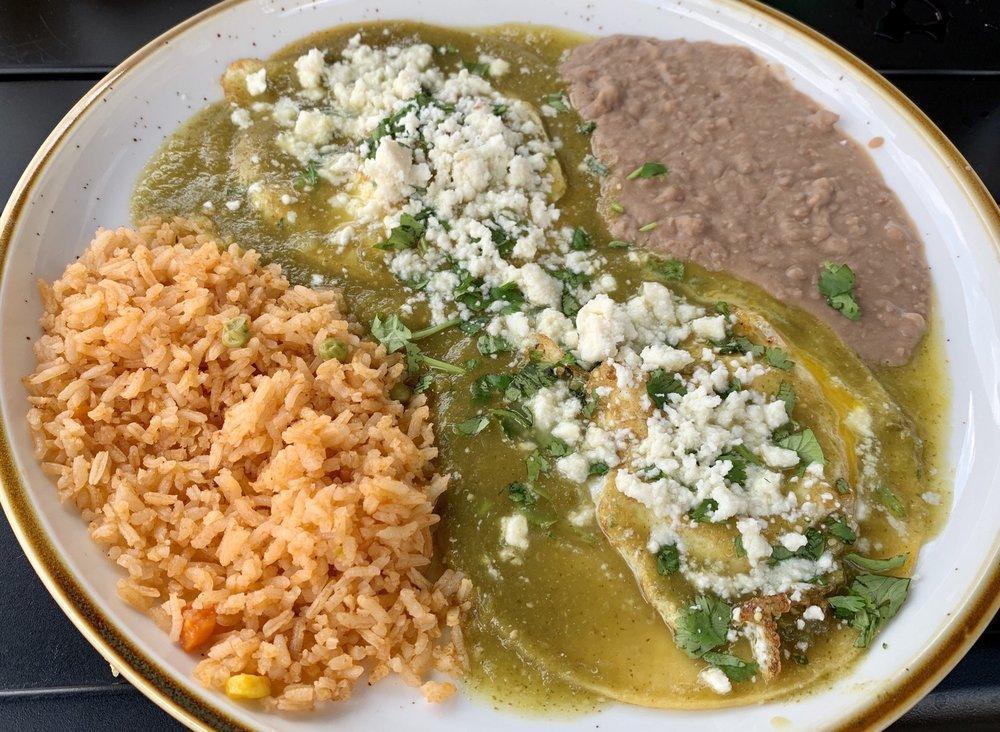 Huevos Rancheros · 2 fried eggs served on a hot fried corn tortilla smothered in ranchera salsa or salsa verde. Topped with cheese and cilantro. Served with rice and beans.