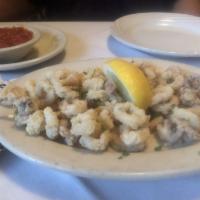 Fried Calamari · Calamari lightly tossed in flour and deep fried to a crispy golden brown. Served with a cock...
