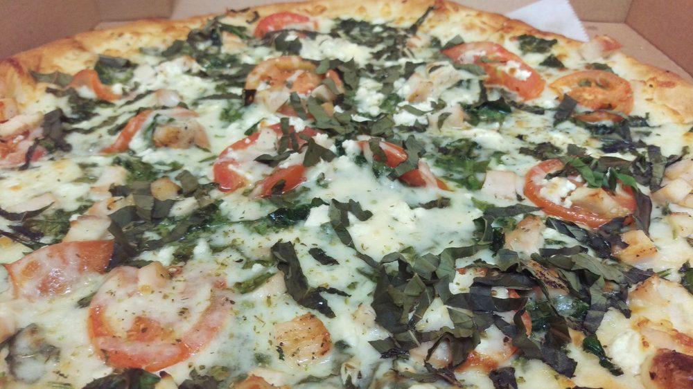 Chicken Rustica Pizza · Grilled chicken with fresh spinach, basil, feta cheese, Roma tomatoes, Wisconsin mozzarella, Sicilian extra-virgin olive oil and fresh garlic.