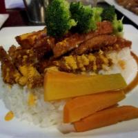 Chicken Katsu · Breaded chicken cutlet served over a bed of steamed rice and coleslaw on the side, drizzled ...