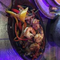 Fajitas · Our fajita peppers and onions are seasoned with our special Mexican spices and served on a s...