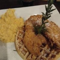 Chicken and Waffle · Large Belgian waffle topped with crispy fried chicken and a side of brown sugar bourbon syrup.