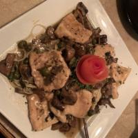 Chicken Piccata · Fresh chicken sauteed with capers and button mushrooms in lemon-butter sauce. Served over ca...