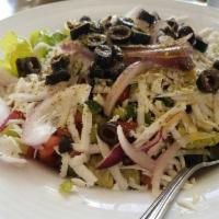 Greek Salad · Fresh romaine lettuce, Roma tomatoes, cucumbers, black olives and red onions topped with fet...