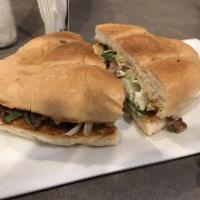 Torta · An authentic Mexican sandwich, homemade bread filled with meat, lettuce, tomato, onions, cil...