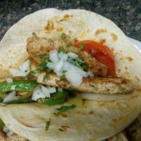 Fajitas · Grilled steak or chicken with sauteed tomatoes, bell peppers and onions. Served with rice, g...