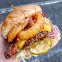 Western Burger · Beef patty, cheese, beef bacon, onion rings, BBQ sauce and toppings include dressing, lettuc...
