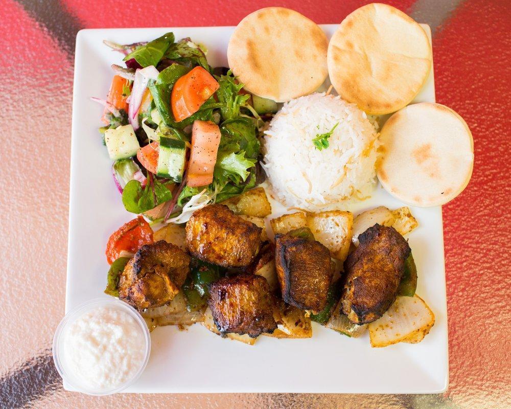 Chicken Kabob Platter · All rice platters come with your choice of fattoush salad or tabouleh salad and white basmati rice. Topped with grilled peppers & onions, 3 of our house-made mini pita pockets and sauce.