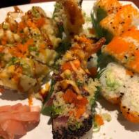 Sea of Love · 8 pieces. Shrimp tempura, cucumber, and avocado inside topped with pepper tuna, crunch, masa...