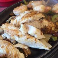 Seafood Fajitas · Served with prawns and tilapia. Served with sizzling hot over a bed of sauteed onions and gr...