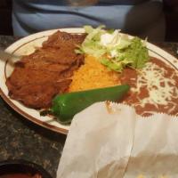 Carne Asada · Steak with green onions and a whole jalapeno on the side prepared the traditional Mexican st...