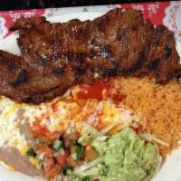 Tampiquena · Marinated flap steak grilled to perfection served with a cheese enchilada.