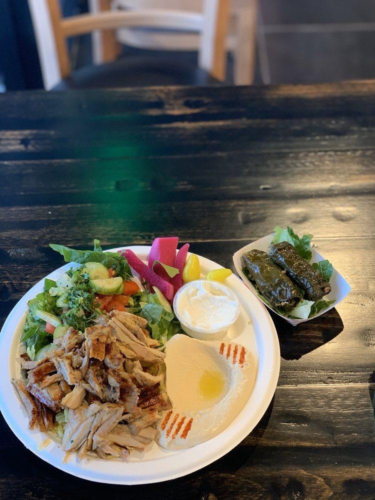 Chicken Shawarma Plate · Marinated chicken broiled and sliced to delicate thin strips. Served with hummus, small house salad, rice, garlic sauce, pickles, and pita bread.