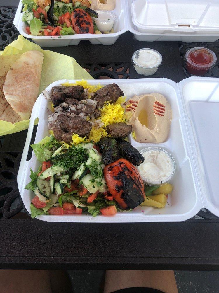 Lamb Kabob Plate · Cubed lamb marinated in a mix of exotic spices and olive oil, skewered and grilled to perfection. Served with hummus, small house salad, rice, 2 pita bread, grilled tomato and jalapeno, sumac and seasoned onions.