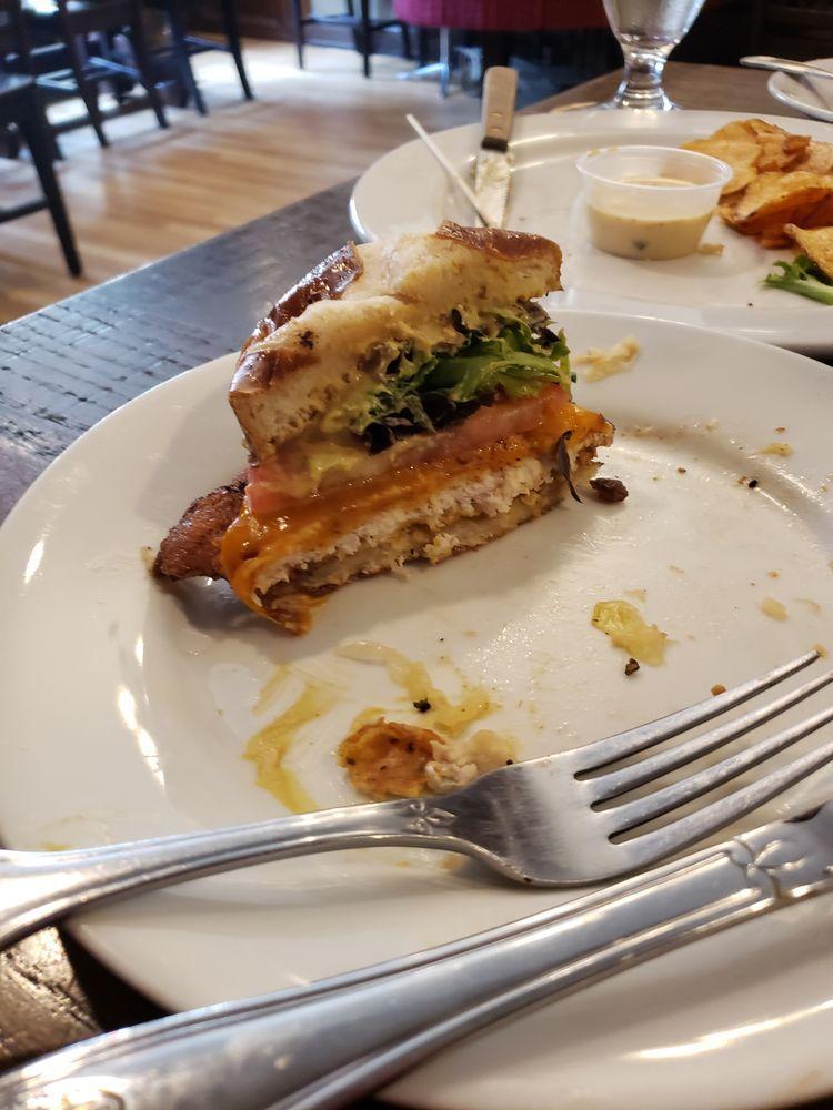 Schnitzel · Lightly breaded pork cutlet, lettuce, tomato, house mustard and cheddar on a warm pretzel bun.