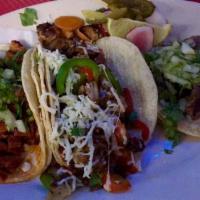 Al Pastor Taco · Fresh seasoned and marinated pork, charbroiled and grilled with pineapple, garnished with ci...