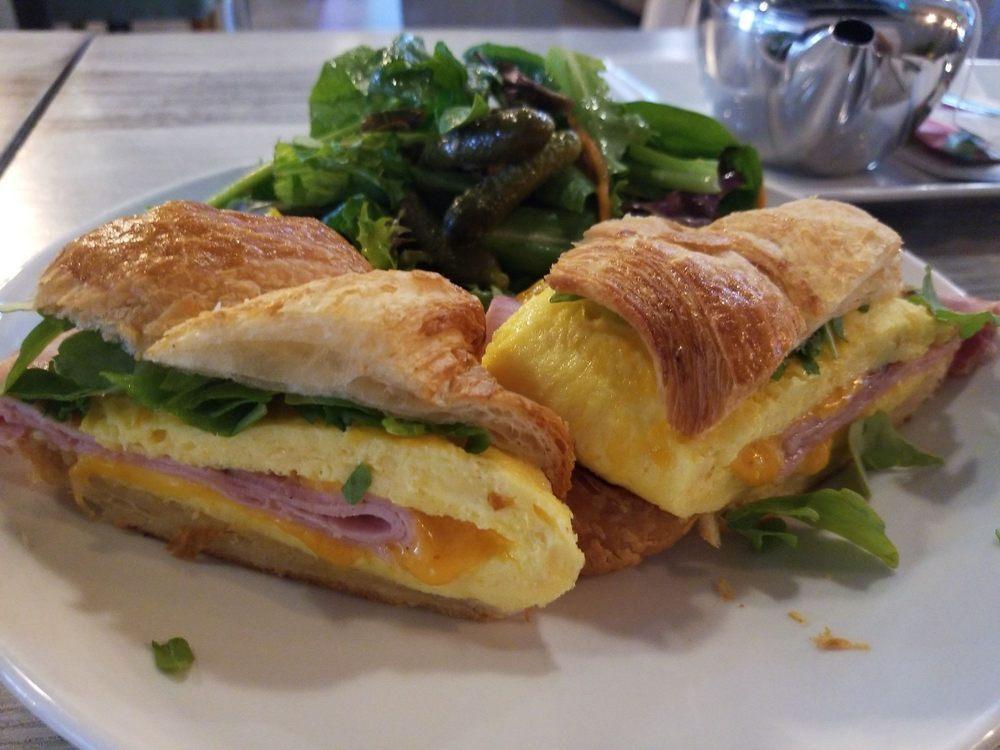 Breakfast Croissant Sandwich · Black Forest ham, cheddar, egg and arugula served with baby mixed greens.