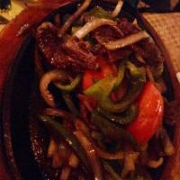 Fajitas · Your choice of marinated strips of grilled chicken breast, skirt steak, assorted veggies, or...