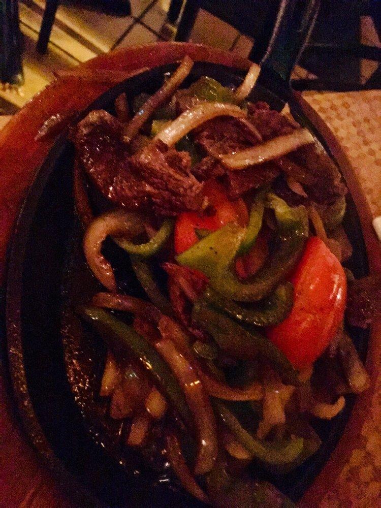 Fajitas · Your choice of marinated strips of grilled chicken breast, skirt steak, assorted veggies, or grilled shrimp served on a hot iron skillet with green peppers, onions, and tomatoes. All fajitas are served with Mexican rice, refried pinto beans, guacamole, sour cream, and warm tortillas.