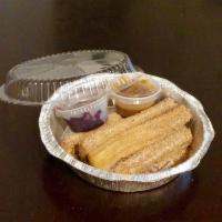 Churros · Warm Mexican doughnuts served with raspberry and chocolate dipping sauces.