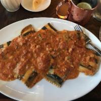 Lobster Ravioli · Lobster and ricotta stuffed ravioli, with shrimp and scallops, in a marinara sauce with a to...