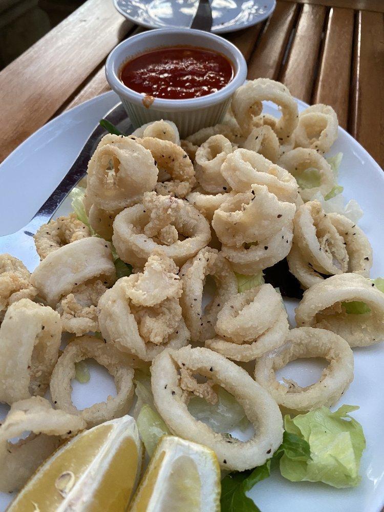 Traditional Fried Calamari · Tender rings and tentacles dredged in flour, fried to perfection and  served with homemade marinara sauce and lemon wedges.